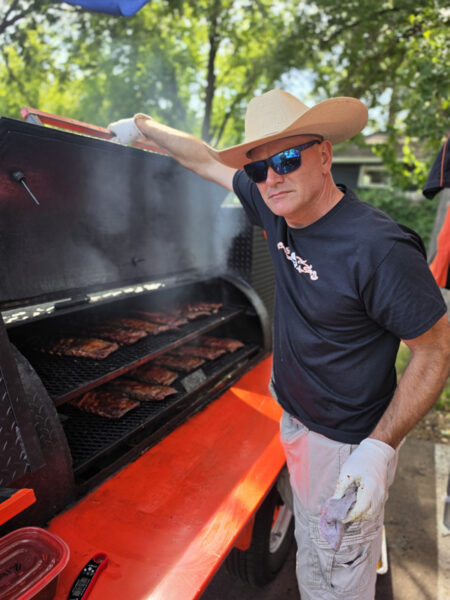 Man Tending Bbq Smoker