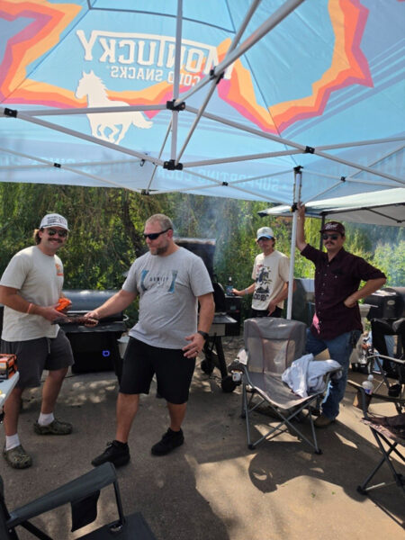 Men Grilling Under Tent